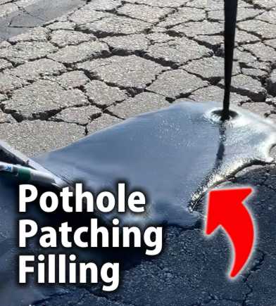 Close-up view of a worker pouring hot bitumen filler into a pothole in asphalt pavement