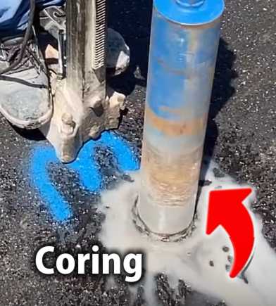A construction worker drilling a hole in the ground to take a sample for coring testing