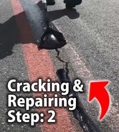 Close-up view of a person wearing gloves and using a pouring tool to fill a long crack in asphalt with hot liquid crack filler